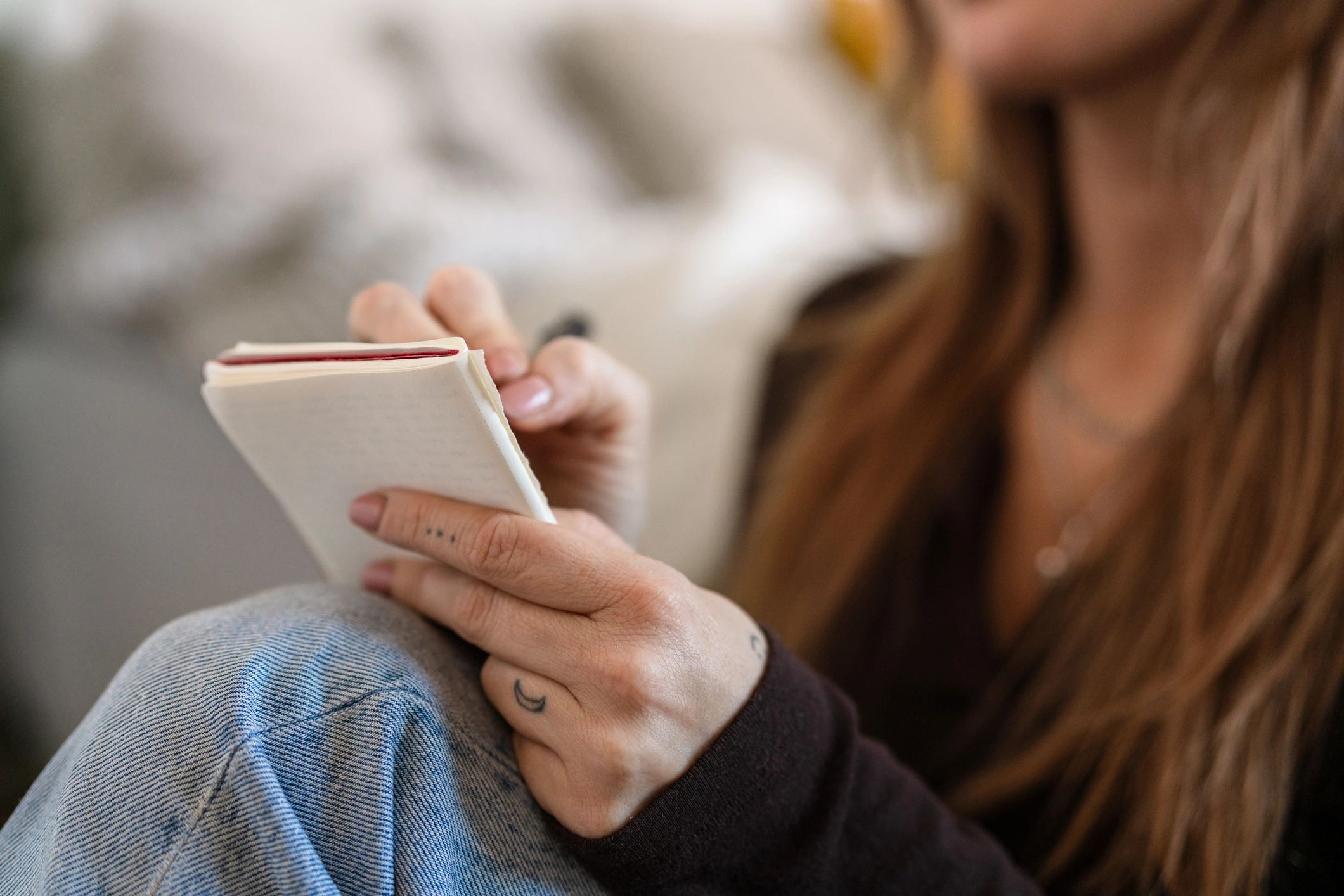 Person reflecting while writing in a journal